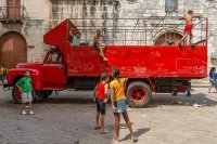 Red truck, children playing, Havana, Cuba 2013