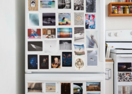 photo of a fridge with photos all over it.