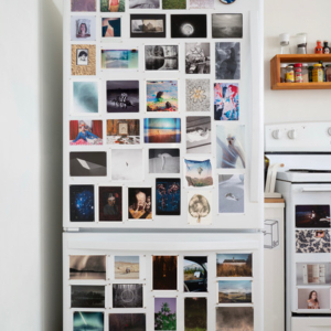 photo of a fridge with photos all over it.